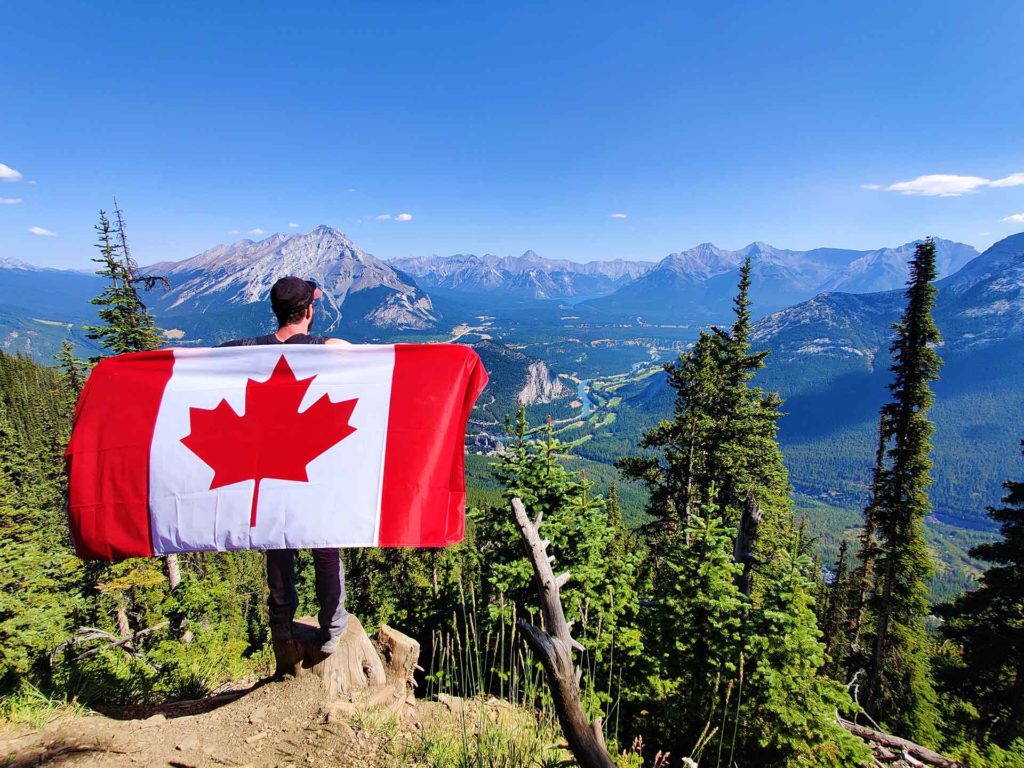 An image of a man holding a Canadian Flag